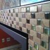 Handmade mosaic glass and stone fireplace border close-up.